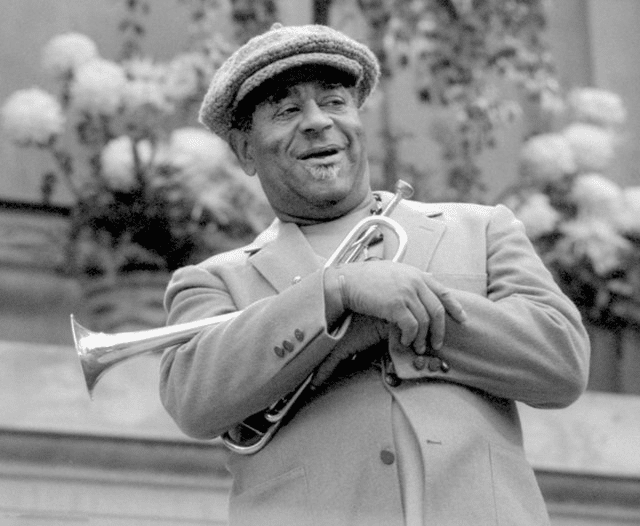 Dizzy Gillespie with his bent trumpet. Photograph by Brianmcmillen, CC BY-SA 4.0, via Wikimedia Commons.